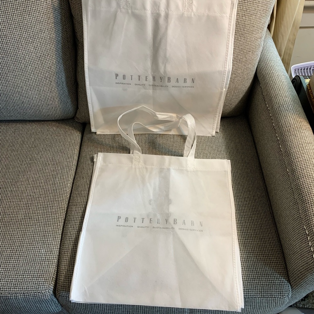 2 Pottery Barn white polypropylene bags with logo